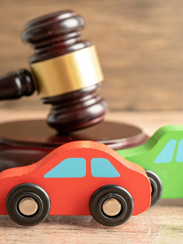 Hammer gavel judge with car vehicle accident, insurance coverage claim lawsuit court case.